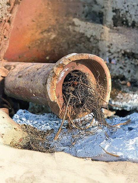 High pressure jet blasting clearing a blocked drain pipe